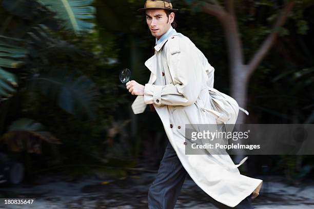 making a hasty getaway - trench coat stock pictures, royalty-free photos & images