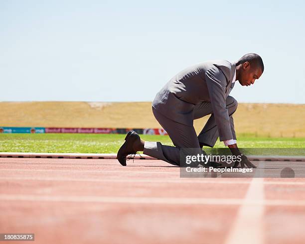 ready to beat his competition - starting block stockfoto's en -beelden