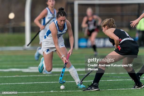 Elle Murray of Assumption University dribbles down the wing as Charlotte Simon of East Stroudsburg University defends during 2023 DII Field Hockey...