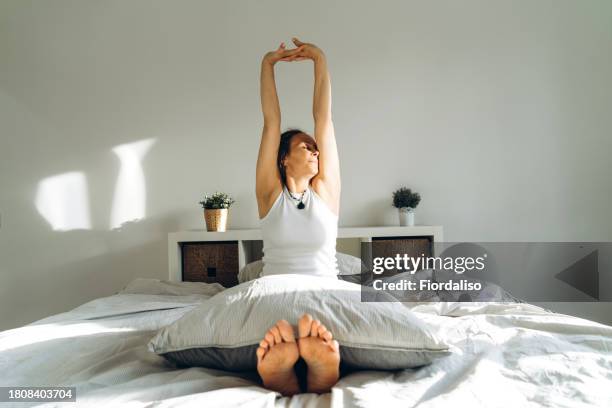 portrait of a woman in the bed - woman pillow stock pictures, royalty-free photos & images