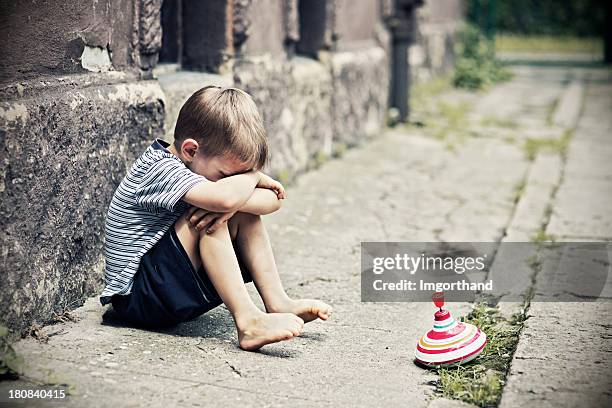 depressed little boy - homeless child stock pictures, royalty-free photos & images