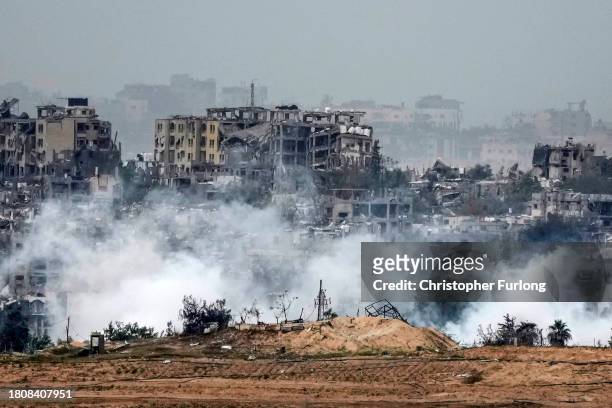 In this photograph taken near the Israeli border with the Gaza Strip, smoke rises over Beit Hanoun in Northern Gaza after an israeli air strikeon...