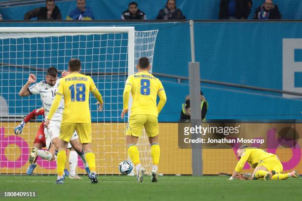 Mykhailo Mudryk of Ukraine crashes to the ground following a challenge by Bryan Cristante of Italy in the penalty area that went unpunished during...