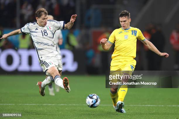 Nicolo Barella of Italy challenges Oleksandr Tymchyk of Ukraine as he plays the ball during the UEFA EURO 2024 European qualifier match between...