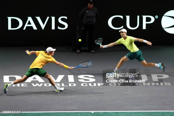 Max Purcell and Matthew Ebden of Australia play a forehand in the Davis Cup Quarter Final doubles match against Jiri Lehecka and Adam Pavlasek of...