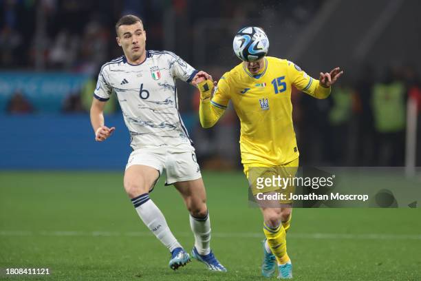 Viktor Tsygankov of Ukraine heads the ball as Alessandro Buongiorno of Italy clsoes in during the UEFA EURO 2024 European qualifier match between...