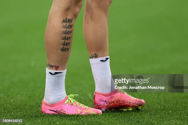 Tattoo reading Again and repeating until fading to the word Gain on the lower limb of Mykhailo Mudryk of Ukraine during the warm up prior to the UEFA...