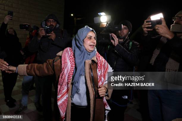 Media surround newly freed Palestinian prisoner Lamees Abu Arqub as she greets supporters following the release of prisoners from Israeli jails in...