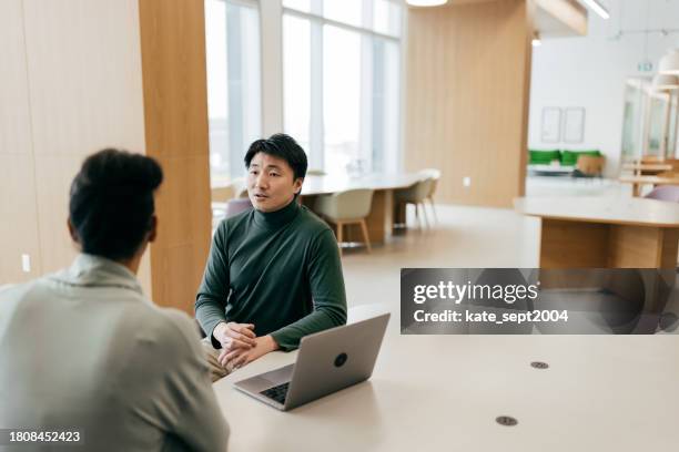 entrepreneur explaining new marketing strategy to colleague at office - employee engagement stock pictures, royalty-free photos & images