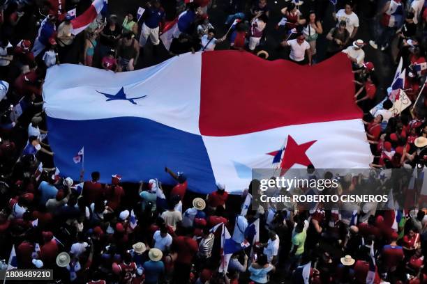 People display a Panamanian national flag as they celebrate the Supreme Court's ruling that declared the contract with Canadian mining company First...