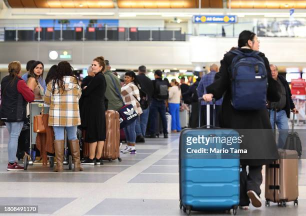 Travelers gather in the international terminal at Los Angeles International Airport ahead of the Thanksgiving holiday on November 22, 2023 in Los...