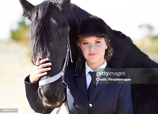 horse and rider share a strong bond... - friesian horse stock pictures, royalty-free photos & images