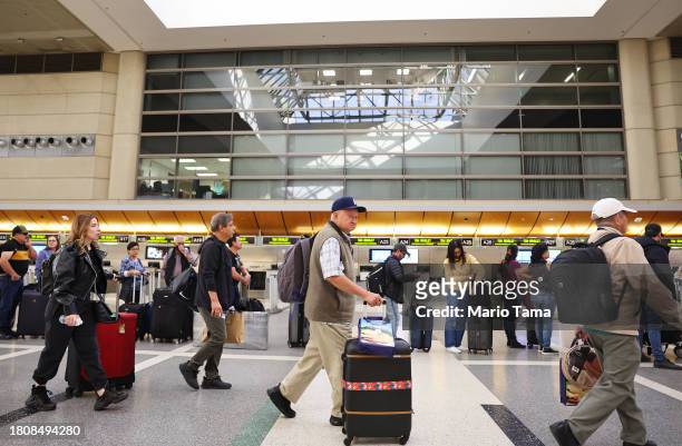 Travelers gather in the international terminal at Los Angeles International Airport ahead of the Thanksgiving holiday on November 22, 2023 in Los...