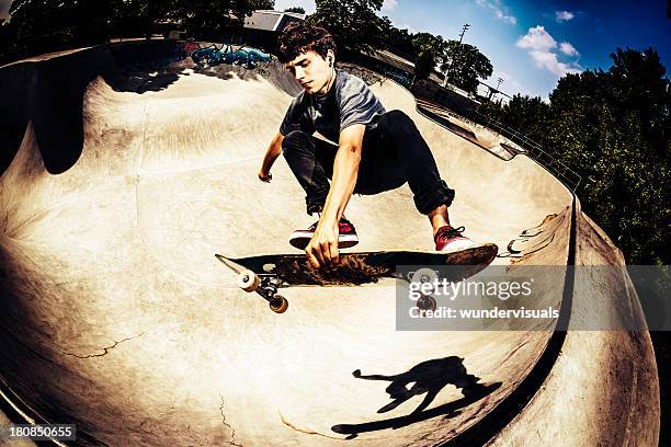 skateboarder doing a trick - skateboarding half pipe stock pictures, royalty-free photos & images