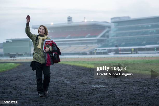 Trainer Gai Waterhouse waves goodbye to other trainers as she leaves a trackwork session at Flemington Racecourse on September 17, 2013 in Melbourne,...