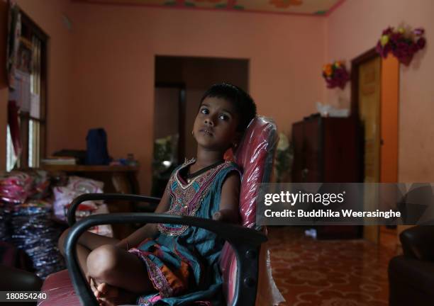 Disabled Sri Lankan ethnic Tamil war survivor child named S. Kasturi, 6 years old, watches television on September 16, 2013 in former rebel city in...