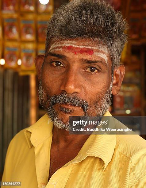 Sri Lankan ethnic Tamil betel vendor looks on at the former rebel capital of Kilinochchi, on September 16, 2013 in Kilinochchi, Sri Lanka. Sri Lanka...