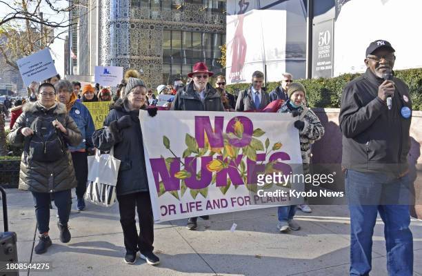 Peace group members march in front of the U.N. Headquarters in New York on Nov. 28 as parties to the U.N. Treaty on the Prohibition of Nuclear...