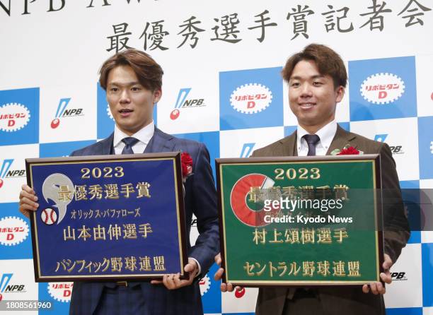 Orix Buffaloes pitcher Yoshinobu Yamamoto and Hanshin Tigers pitcher Shoki Murakami pose after winning Japanese pro baseball's MVP awards in Tokyo on...