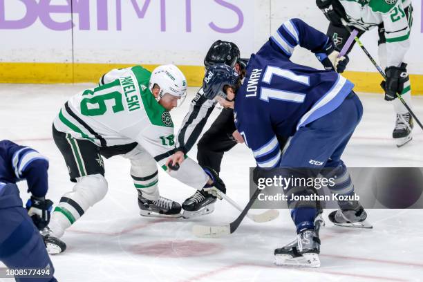 Joe Pavelski of the Dallas Stars and Adam Lowry of the Winnipeg Jets take a first period face-off at the Canada Life Centre on November 28, 2023 in...