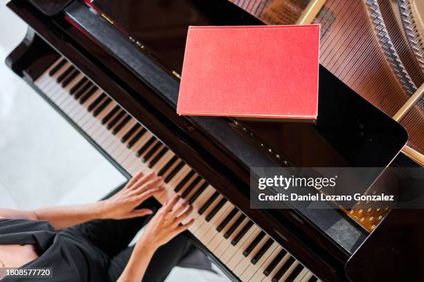 crop woman playing piano with notebook on top support - speech rehearsal stock pictures, royalty-free photos & images