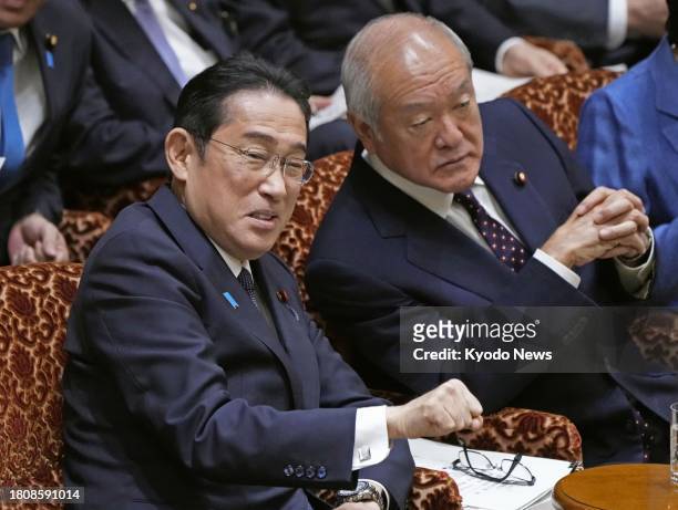 Japanese Prime Minister Fumio Kishida and Finance Minister Shunichi Suzuki attend a House of Councillors budget committee session in Tokyo on Nov....
