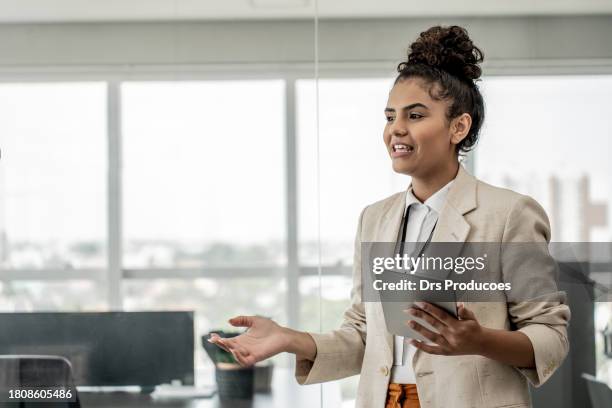 manager instructing employees in modern office - briefs stock pictures, royalty-free photos & images