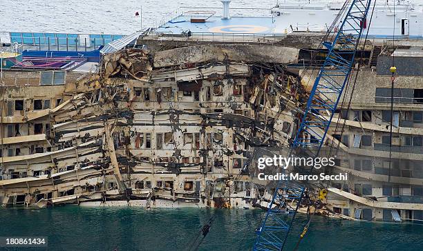 The severely damaged side of the stricken Costa Concordia is visible after the parbuckling operation succesfully uprighted the ship around 4 am on...
