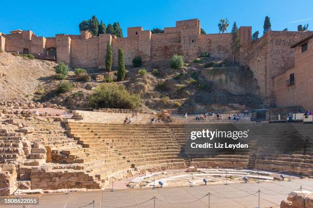 tourists at the roman theatre and alcazaba in málaga; spain; - costa del sol málaga province stock pictures, royalty-free photos & images