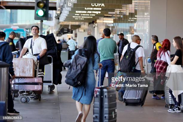 Travelers gather at Los Angeles International Airport ahead of the Thanksgiving holiday on November 22, 2023 in Los Angeles, California. AAA predicts...