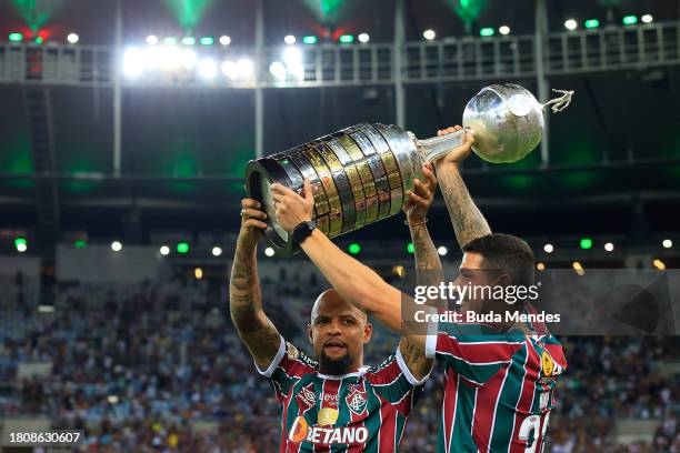 Felipe Melo and Nino of Fluminense enter the field with the Copa Libertadores Championship Cup prior to the match between Fluminense and Sao Paulo as...