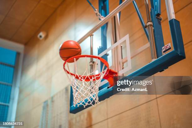 basketballkorb und ein basketballball darauf - basketballkorb stock-fotos und bilder