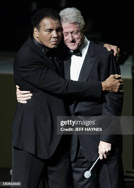 Boxing legend Muhammad Ali hugs former US President Bill Clinton on stage, 19 November 2005, during the Grand Opening Gala for the Muhammad Ali...