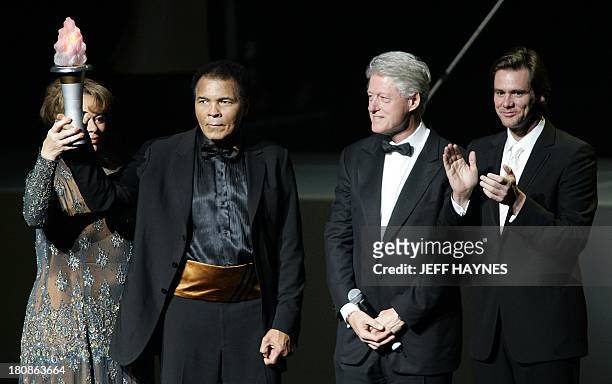 Boxing legend Muhammad Ali and wife Lonnie along with US President Bill Clinton and friend and actor Jim Carrey on stage, 19 November 2005, during...