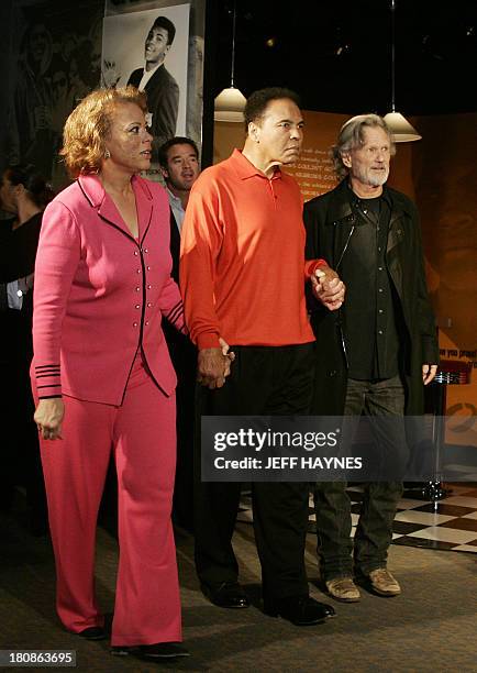 Muhammad Ali walks with wife Lonnie and musican Kris Kristofferson at the Muhammad Ali Center 18 November, 2005 in Louisville, KY before the grand...