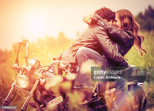 young couple in sunset - cool man leather stock pictures, royalty-free photos & images