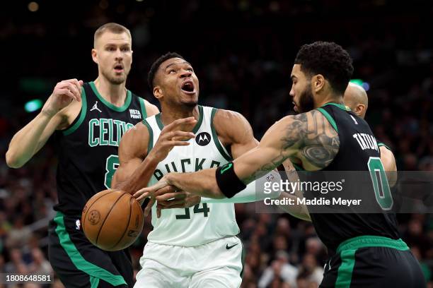 Jayson Tatum of the Boston Celtics blocks a shot from Giannis Antetokounmpo of the Milwaukee Bucks during the first quarter at TD Garden on November...