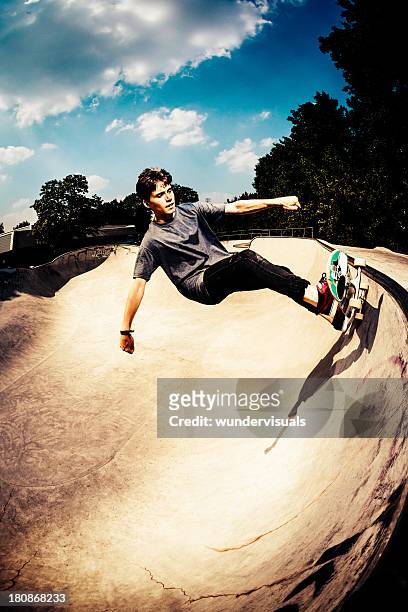 skateboarder grinding in skatepark - skateboarding half pipe stock pictures, royalty-free photos & images
