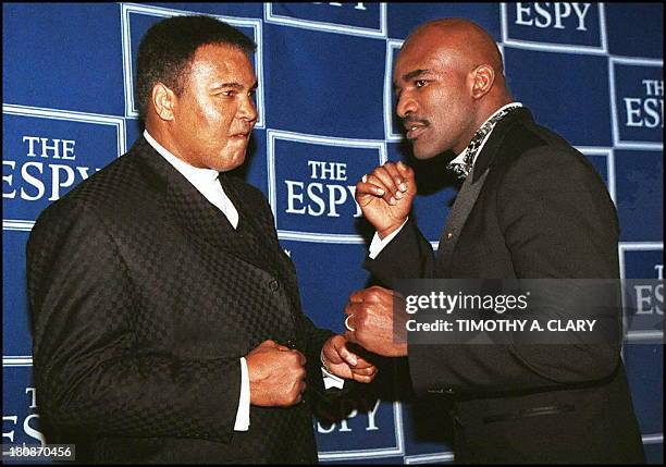 Heavyweight Champions Muhammad Ali and Evander Holyfield play around for the cameras after recieving their ESPY Awards at the 5th Annual ceremony at...