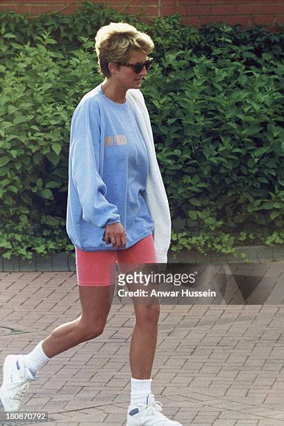 Diana, Princess of Wales, wearing a pale blue sweatshirt, pink cycling shorts and sunglasses, leaves Chelsea Harbour Club on August 24, 1994 in...