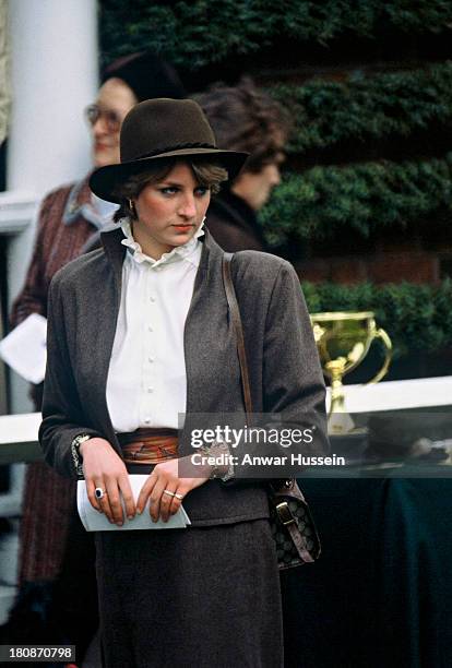 Lady Diana Spencer, wearing a brown suit by Bill Pashley, stands in the parade ring at Sandown Park Racecourse on March 13, 1981 in Sandown, United...