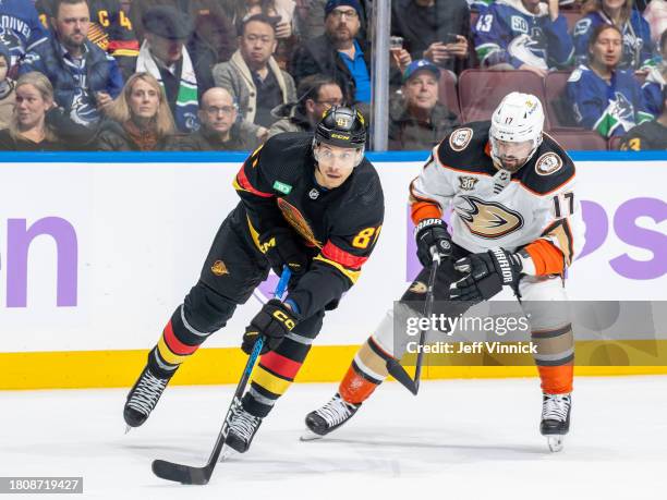 Dakota Joshua of the Vancouver Canucks and Alex Killorn of the Anaheim Ducks battle for the puck during the first period of their NHL game at Rogers...