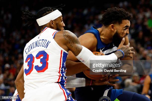 Karl-Anthony Towns of the Minnesota Timberwolves drives to the basket while Robert Covington of the Philadelphia 76ers defends in the second quarter...
