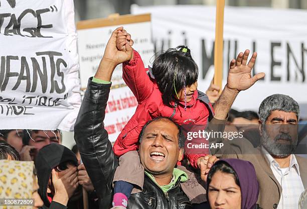 Protestors take part in a demonstration gathering Afghan refugees protesting against Belgian State Secretary of Home Affairs Maggie De Block's policy...