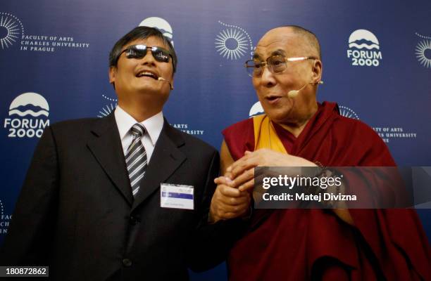 Blind Chinese civil right activist Chen Guangcheng and Tibetan spiritual leader the Dalai Lama pose for photographers before the panel discussion...