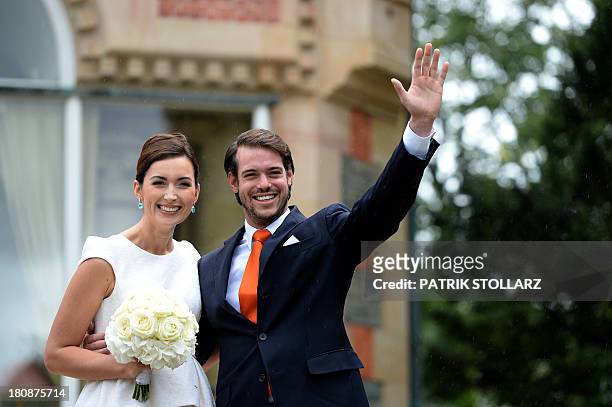Prince Felix of Luxembourg and German student Claire Lademacher wave while posing for pictures after their Civil Wedding Ceremony at Villa Rothschild...