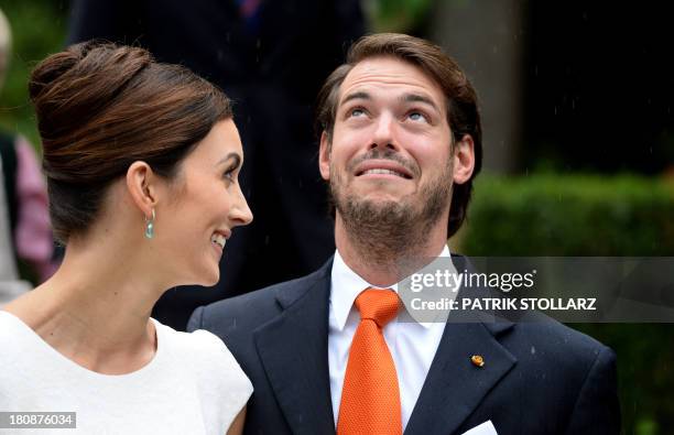 Prince Felix of Luxembourg and German student Claire Lademacher look at the rain as they pose for pictures after their Civil Wedding Ceremony at...