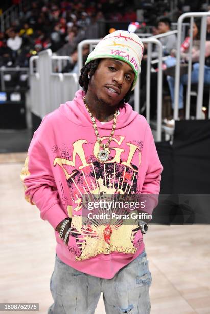 Singer Jacquees attends the game between the Brooklyn Nets and the Atlanta Hawks at State Farm Arena on November 22, 2023 in Atlanta, Georgia. NOTE...