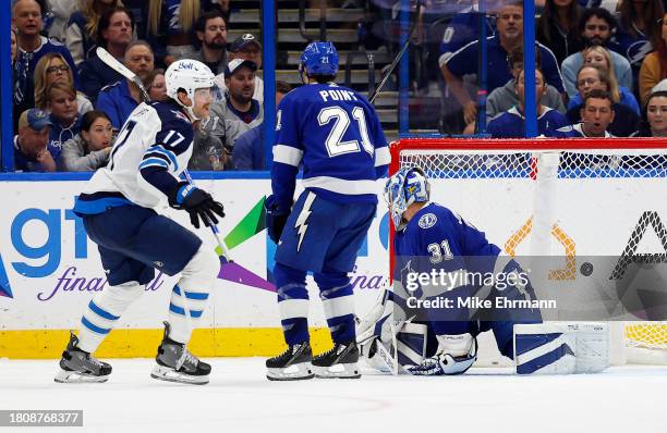 Adam Lowry of the Winnipeg Jets celebrates a goal in overtime during a game against the Tampa Bay Lightning at Amalie Arena on November 22, 2023 in...