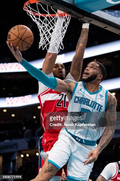 Miles Bridges of the Charlotte Hornets drives to the basket while guarded by Daniel Gafford of the Washington Wizards in the third quarter during...